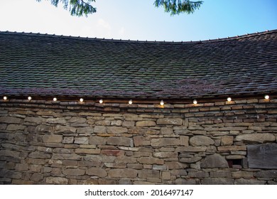 electrical installation with light bulbs on a stone wall at Evangelical Fortified Church Crit, Brasov, Romania 2019