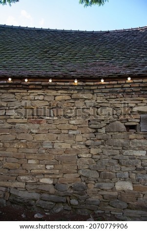 electrical installation with light bulbs on a stone wall at Evangelical Fortified Church Crit, Brasov, Romania 2019