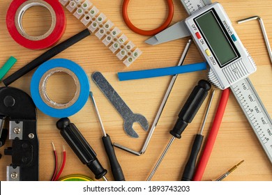 Electrical installation tools scattered on the wooden surface