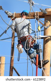 an electrical lineman working on lines