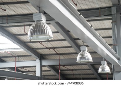 Electrical and mechanical equipment system installation in new factory building.High bay lighting installation in construction site.