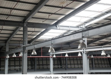 Electrical and mechanical equipment system installation in new factory building.High bay lighting installation in construction site.