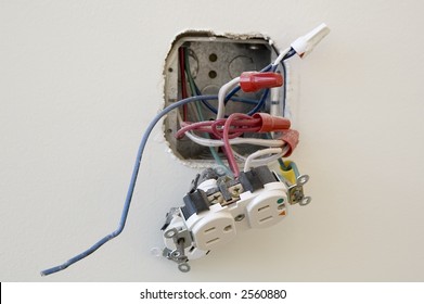 Electrical outlet during installation in office wall