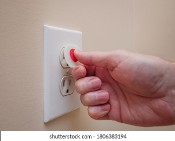 Electrical Outlet With Electricity Safety Cover To Prevent Child Electrocution. Baby Proofing Household Power Sockets With Plastic Plug Inserts.