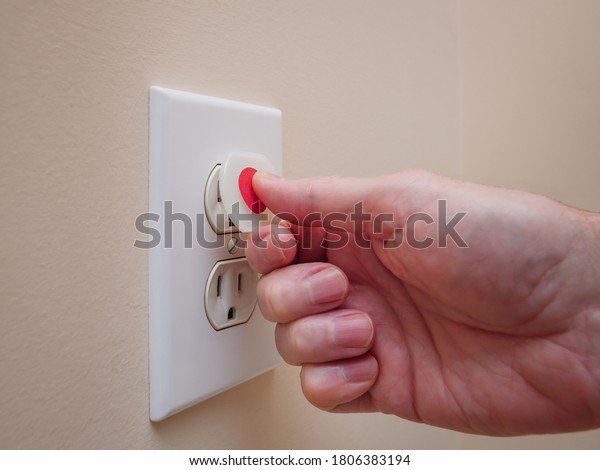 Electrical outlet with electricity safety\
cover to prevent child electrocution. Baby proofing household power\
sockets with plastic plug\
inserts.