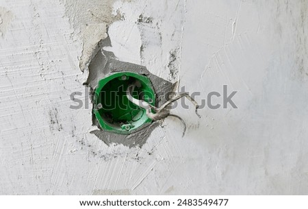Electrical outlet. Install outlet box with Electrical socket in wall. New Plug socket in wall in room. Electrical plug. Socket in wall with wires during Repair in the house. Installing an outlet. 