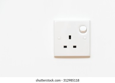 Electrical Outlet In The UK, Power Socket On White Wall With Copy Space