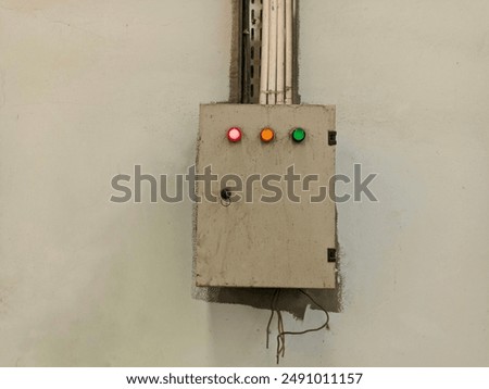 The electrical panel box is worn and the indicator lights are on