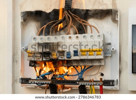 Electrical panel on fire in a home during the day causing smoke and damage to wires and circuitry