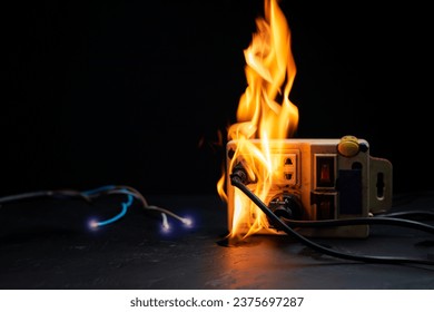An electrical plug fire is caused by a short circuit of electrical current. Concept of prevention of danger. Using non-standard equipment, damaged equipment