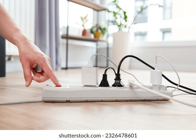 Electrical plug in outlet socket at home. Energy efficiency concept - Shutterstock ID 2326478601