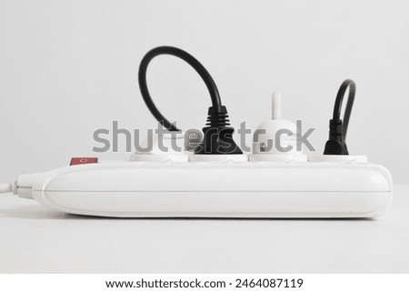 Electrical plug in outlet socket at home isolated on white background, Outlet, Electric Plug, Power Cable, a power button and a connected electrical plug