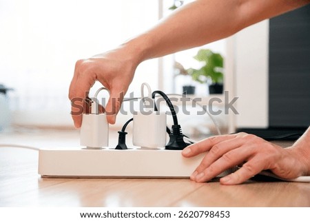 Electrical plug in outlet socket at home. Energy efficiency concept