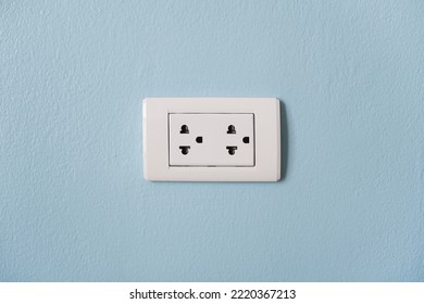 Electrical Plug Socket On The Blue Cement Wall. Energy Use In Home. Electricity Consumption.