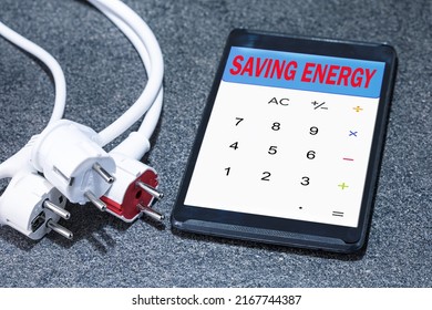 Electrical plugs with digital tablet with SAVING ENERGY text. Energy efficiency, saving energy concept.