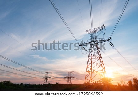 Electrical power lines and towers at sunset.