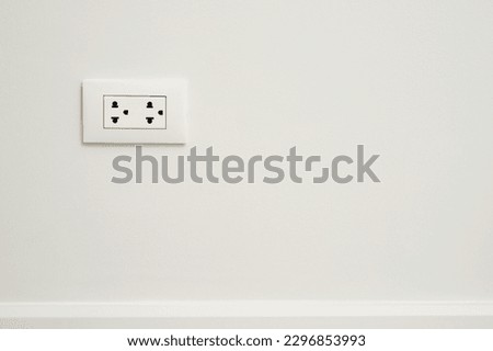Electrical power socket plug outlet on concrete white wall.