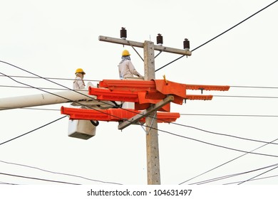 An Electrical Power Utility Worker In A Bucket Fixes The Power Line.