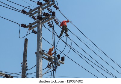 An Electrical Power Utility Worker Fixes The Power Line.