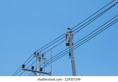 An Electrical Power Utility Worker Fixes The Power Line.