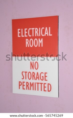 Electrical room no storage permitted sign posted on the wall