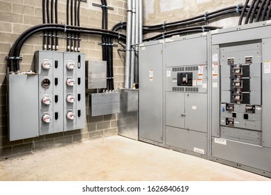 Electrical Room Of Residential Or Commercial Building. Multiple Smart Meters, Main Power Breaker, Meter Stacks And Cabinets. Perspective View