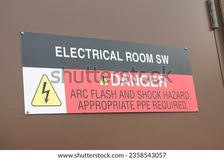 electrical room sw danger arc flash and shock hazard appropriate ppe required sign on brown metal entrance door