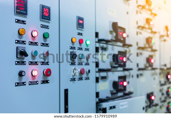 Electrical selector switch,button\
switch,Electrical switch gear at Low Voltage motor control center\
cabinet in coal power plant. blurred for\
background.