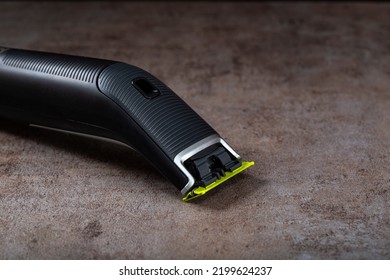 Electrical shaver on a dark background with copy space - Shutterstock ID 2199624237