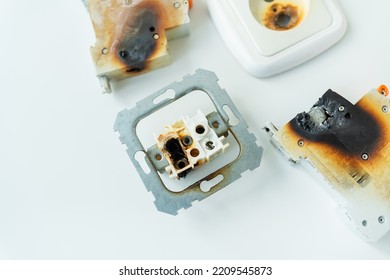 Electrical Short Circuit. Failure Caused By Burning Wire And Rosettes Melted Plug In House. Electrical Appliances Ignition. Burnt Socket And Circuit Breaker Due To Shortcut Circuit. Safety Regulations