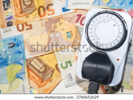 an electrical socket and euro notes
