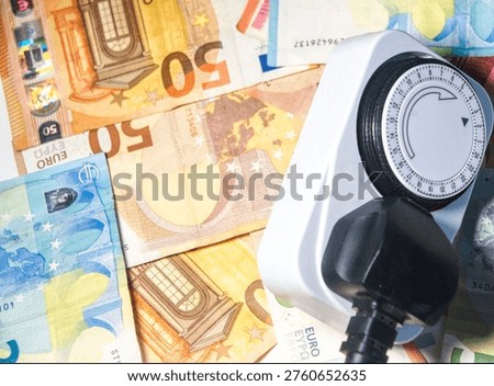 an electrical socket and euro notes