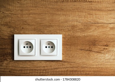 Electrical Socket Isolated On Wooden Kitchen Wall. Renovated Studio Apartment Power Supply Background. Empty Copy Space White Plastic Double Power Outlet.