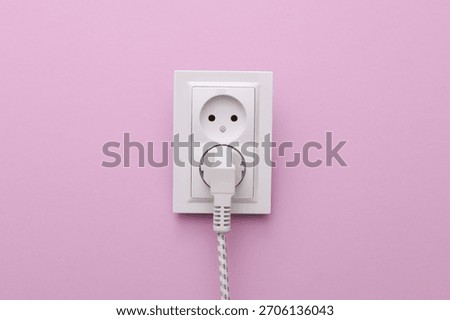 Electrical sockets and electrical plug on a purple background