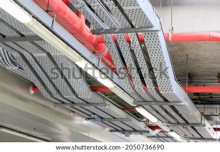 electrical steel pipe line, Electrical cable wire way on wall, cable routing between electrical distribution panel with equipment, industry construction concept background.
