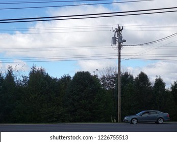 an electrical step-down transformer on a pole with wires crossing the sky; Harrisonburg, VA, USA