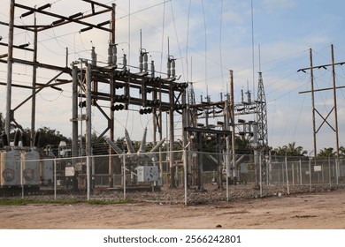 The electrical substation is a complex network of metal towers and wires.