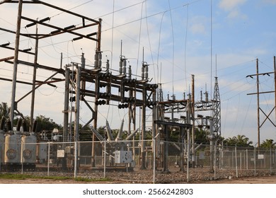 The electrical substation is a complex network of metal towers and wires.
