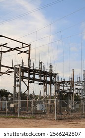 The electrical substation is a complex network of metal towers and wires.