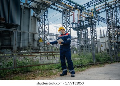 An Electrical Substation Engineer Inspects Modern High-voltage Equipment In A Protective Mask . Energy. Industry