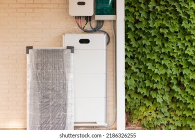 Electrical system for solar energy installation with solar panel, battery and inverter with plants on one side