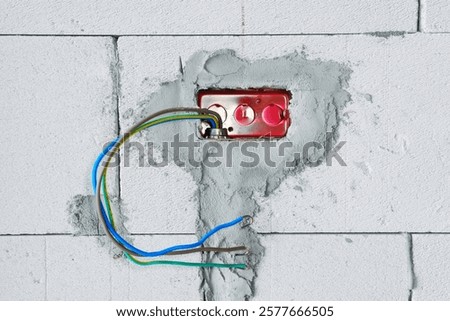 Electrical systems embedded in walls .Hole inside the concrete wall for wires and electric plugs on construction site before interior decorating