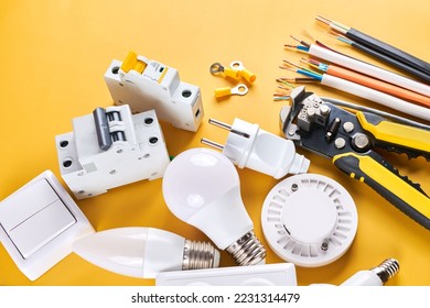 Electrical tools set with dimmer switch isolated on yellow background with copy space, controllable lighting. Saving energy concept, building and renovation