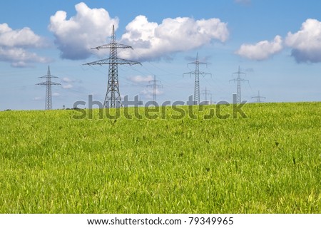 Electrical towers on a meadow in spring time