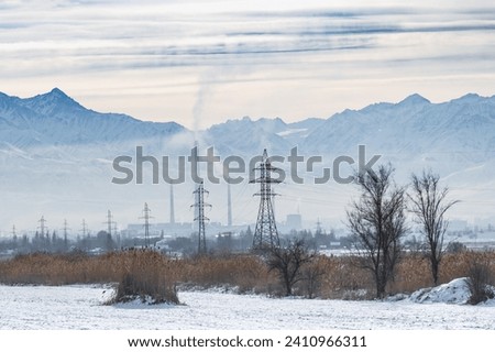 Electrical towers supporting high voltage power lines in the mountainous areas of Kyrgyzstan. Power transmission line in a hard-to-reach place in the mountains.Electrification.