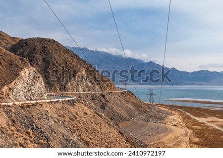 Electrical towers supporting high voltage power lines in remote mountainous areas of Kyrgyzstan.
