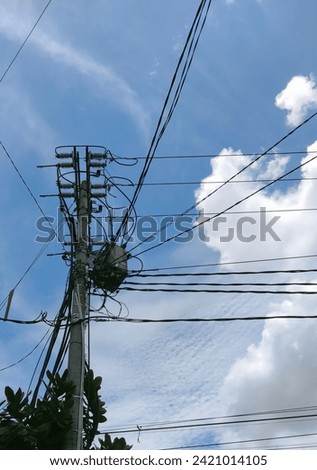 Electrical transformer during the day. Great for cables, city, electricity, danger, background, industrial, distribution, electrical, outdoor, pole, volt, blue, high, sky, power, watt, technology.