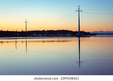 Electrical  transmission towers carrying high voltage lines over the sea at the shore of the Gulf of Bothnia, Finland - Powered by Shutterstock