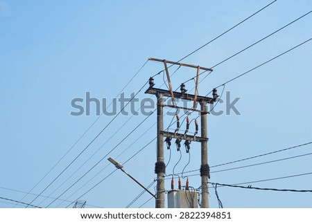 Electrical Utility Pole with Power Lines Against Blue Sky