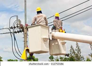 Electrical Utility Worker In A Bucket Fixes A Problem With A Power Line.